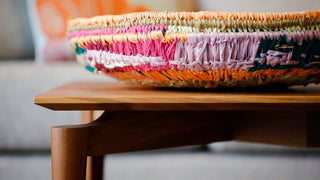 Colorful woven basket on wooden table - I3A3258