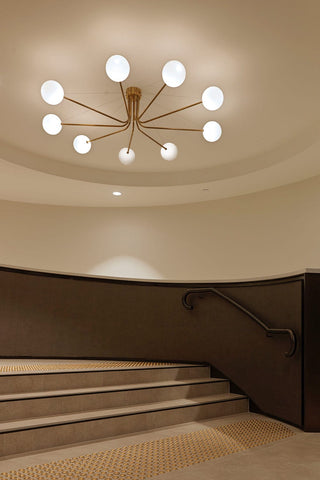 ILANEL Orbit 6 chandelier over curved staircase