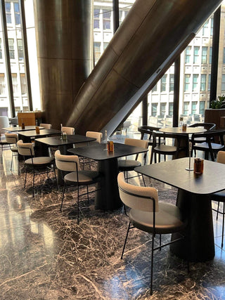 Restaurant seating area with tables and chairs.