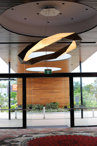 Modern geometric ceiling light fixture over entrance