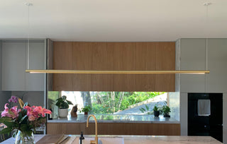 Kitchen with modern light fixture and garden view