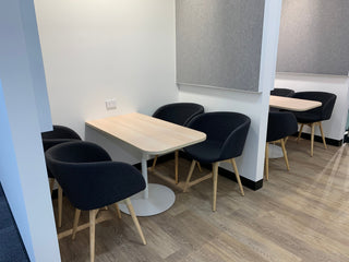 Tables and chairs in a modern office space.