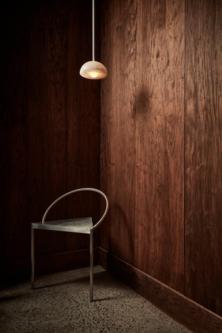 Marz Designs Aurelia White Onyx pendant light over modern chair
