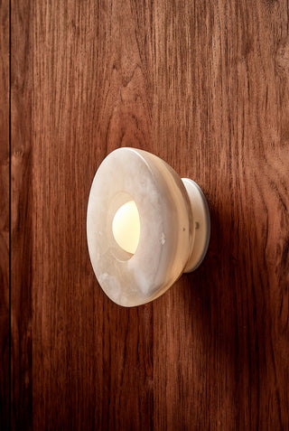 Marz Designs Aurelia White Onyx Sconce on wood