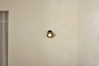 Marz Designs Terra 0 articulating wall light, chartreuse, on white wall.