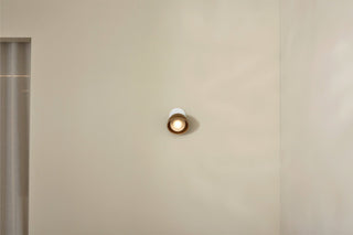 Marz Designs Terra 0 articulating light, chartreuse and white, on wall.