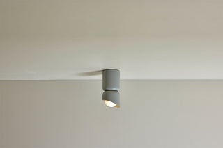Marz Designs Terra 1.5 surface sconce in fog, clear frosted, on white ceiling.
