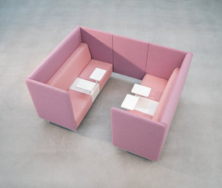 Pink U-shaped booth with small tables