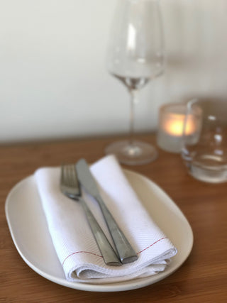 NASH Eir white napkins on plate with cutlery and glass
