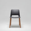 Chair with dark gray seat and wooden legs on a white background