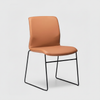 Tan leather look chair with black metal legs on a white background