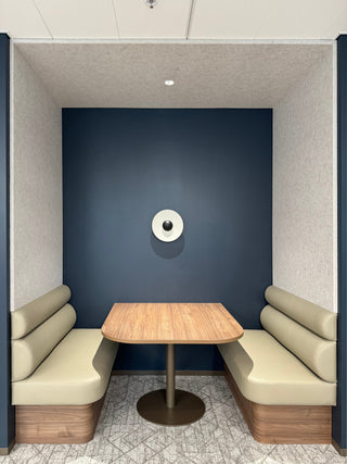 Office booth with table and seating, edited photo.
