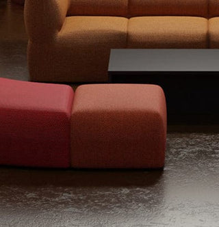 Red and orange ottomans with sofa and table.