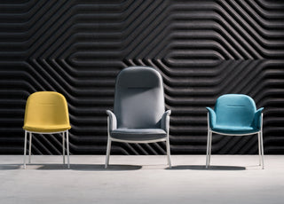 Three modern chairs against a textured wall