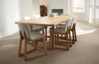 Wooden dining table with chairs in a bright room
