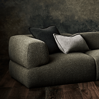 Modern green sofa with pillows, screenshot from 2023.