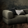 Modern green sofa with pillows, screenshot from 2023.