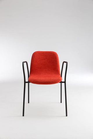 Modern red chair with black arms.