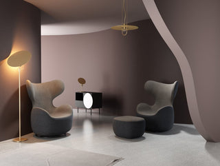 Modern living room with curved design and stylish furniture.