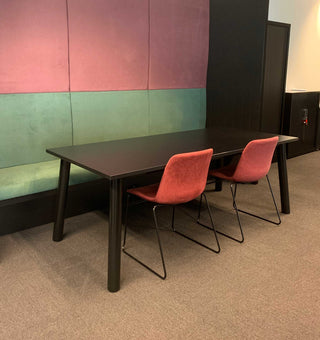 Tubular table with red chairs