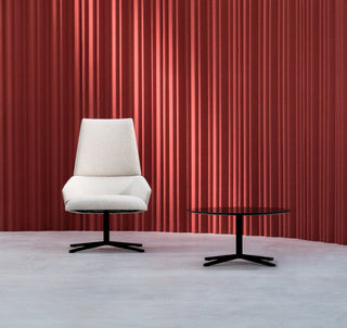 White chair and table in front of red wall