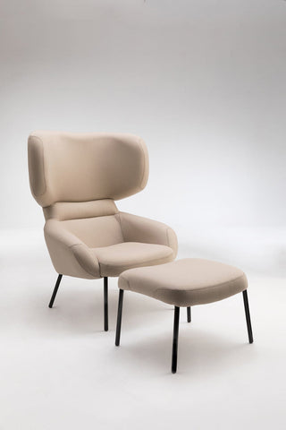 Beige armchair and ottoman.