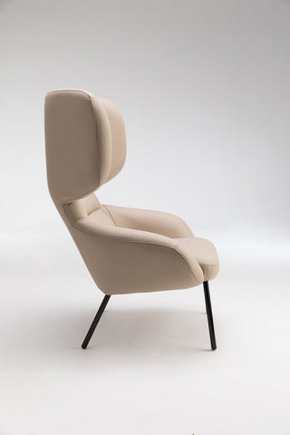 Beige armchair with high back.