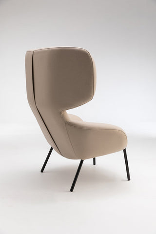 Beige high-backed chair with black legs.