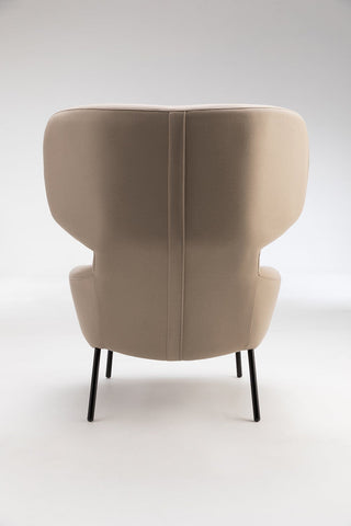 Beige armchair with black legs.