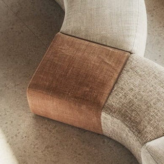 Upholstered sofa with brown and beige fabric.