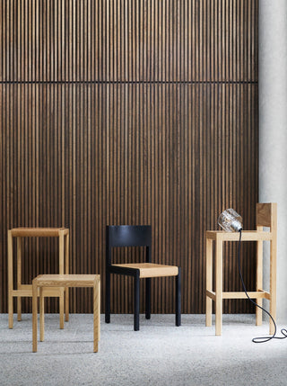 Chairs in front of a wood slat wall.