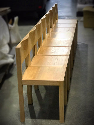 Wooden bench with wavy backrests.