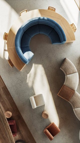 Overhead view of a modern seating area with curved sofa and chairs.