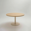 Round wooden top table on a grey background
