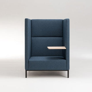 Blue high-backed chair with small side table.