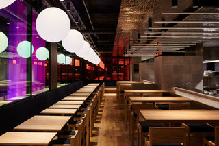 Restaurant interior with tables and spherical lights.