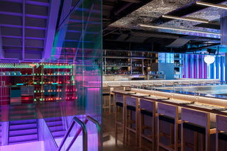 Interior view of a modern bar with neon lighting.