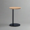 Round side table with black base and wood top