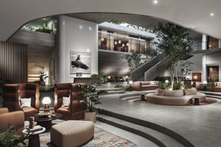 Modern hotel lobby with seating and trees.