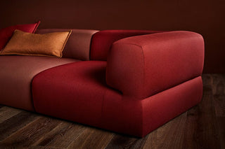 Red and brown sectional sofa with pillows.