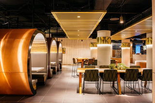 Modern office interior with seating and tables.