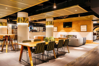 Interior of a modern dining area with tables and seating.