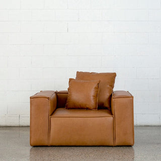 Baxter leather armchair with pillows