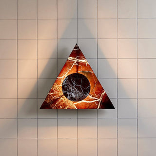 Triangle art with circle detail on tiled wall