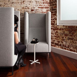 Connectedbooth with phone and person using it.