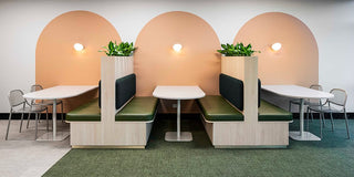 Dendy Infosys office interior with booths and tables.