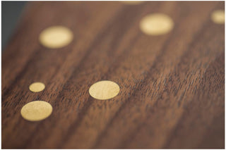 Wooden surface with inlaid gold circles