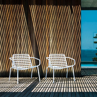 Didier Bombala white outdoor chairs on wooden deck