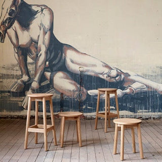 Didier Fable oak stools in front of mural