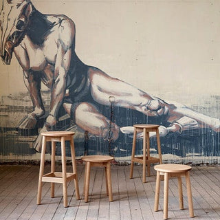 Didier Fable oak stools in front of mural